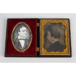 A daguerreotype case. The hinged cover having high relief scene of figure with a horse, opening to