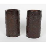 A pair of Chinese bamboo vases. Each having low relief carved decoration depicting river scene