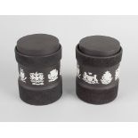 A pair of 20th century Wedgwood black basalt jars, each having asymmetric jasperware band