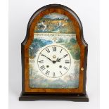 A reproduction walnut mantel clock. Decorated with various hunting scenes to the arch and spandrels,