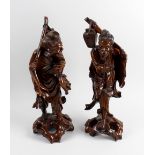 A pair of Japanese carved rootwood figures each modelled as a fisherman, with inset ivory eyes and