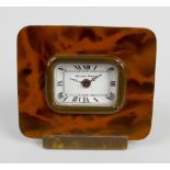 A Matthew Norman alarm clock. The white enamelled rectangular dial having Roman numerals and