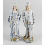 A pair of late 19th century tinted bisque porcelain figurines modelled as a female in hand painted