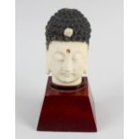 A late 19th century carved ivory figure. Modelled as the head of an Eastern deity, the carved hair