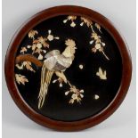 A pair of shibayama circular black lacquered wall panels, with applied mother of pearl decorations