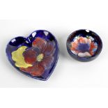 Two items of Moorcroft pottery. Comprising: a Clematis pattern heart-shaped dish, with dark blue