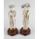 A pair of late 19th century carved ivory figures. Modelled as a Mandarin Emperor and Empress, each