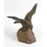 A Franz Bergman cold painted bronze study depicting an eagle with outstretched wings, resting upon a