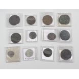 A collection of sixteen bronze coins, each in individual plastic sleeve. All items displaying