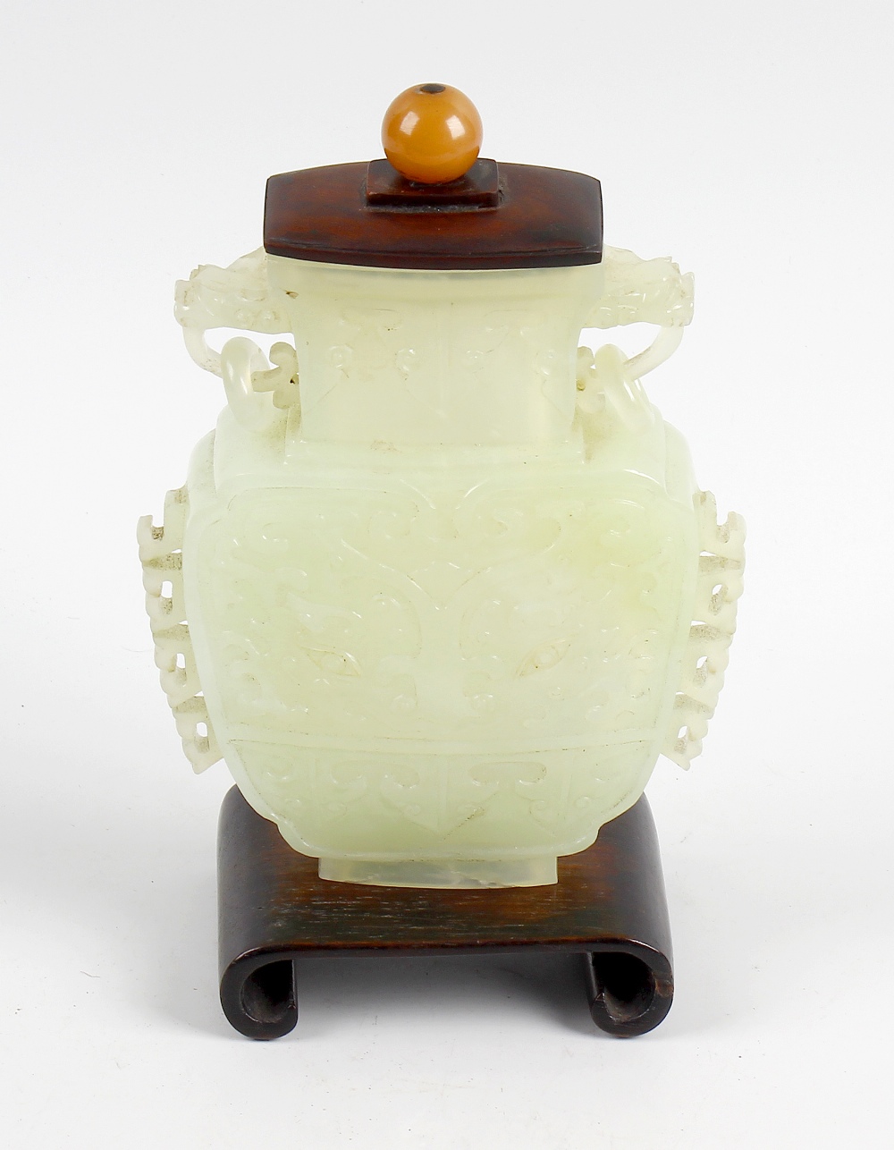 A Chinese jadeite vase, with twin mask and ring carry handles and carved panelled decorations,