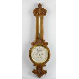 A late Victorian/early Edwardian wheel barometer. The circular dial measuring from 28 to 31 inches