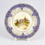 A Royal Worcester plate. The central panel printed and painted with a rural cottage signed L. Sivad,