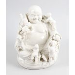 A Chinese Dehua blanc-de-chine figure modelled as Hotei in traditional seated pose. 8 1/2 22 1/4cm