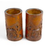 A pair of 19th century Chinese carved bamboo brush pots. Each of cylindrical form carved in high