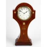 An Art Nouveau inlaid mahogany 'balloon' mantel clock. Having a 3.5-inch white Arabic dial, the