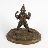 A small 19th century bronze figure. Modelled as an acrobat or performer in open stance, stood upon