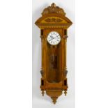 A late 19th/early 20th century walnut and mahogany veneered twin weight Vienna wall clock. The 6.