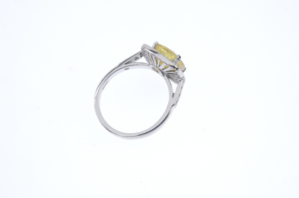 A sapphire and diamond dress ring. The cushion-shape yellow sapphire, with brilliant-cut diamond - Image 4 of 4