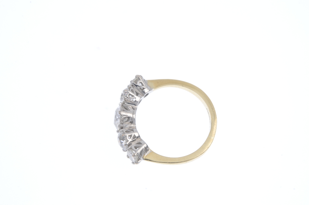 An 18ct gold diamond five-stone ring. The graduated old-cut diamond line, to the plain band. - Image 3 of 4