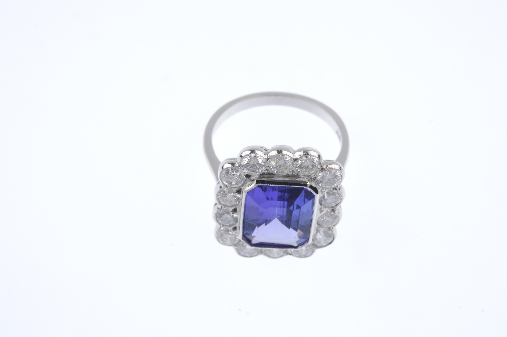 A tanzanite and diamond cluster ring. The rectangular-shape tanzanite collet, within a brilliant-cut - Image 2 of 4