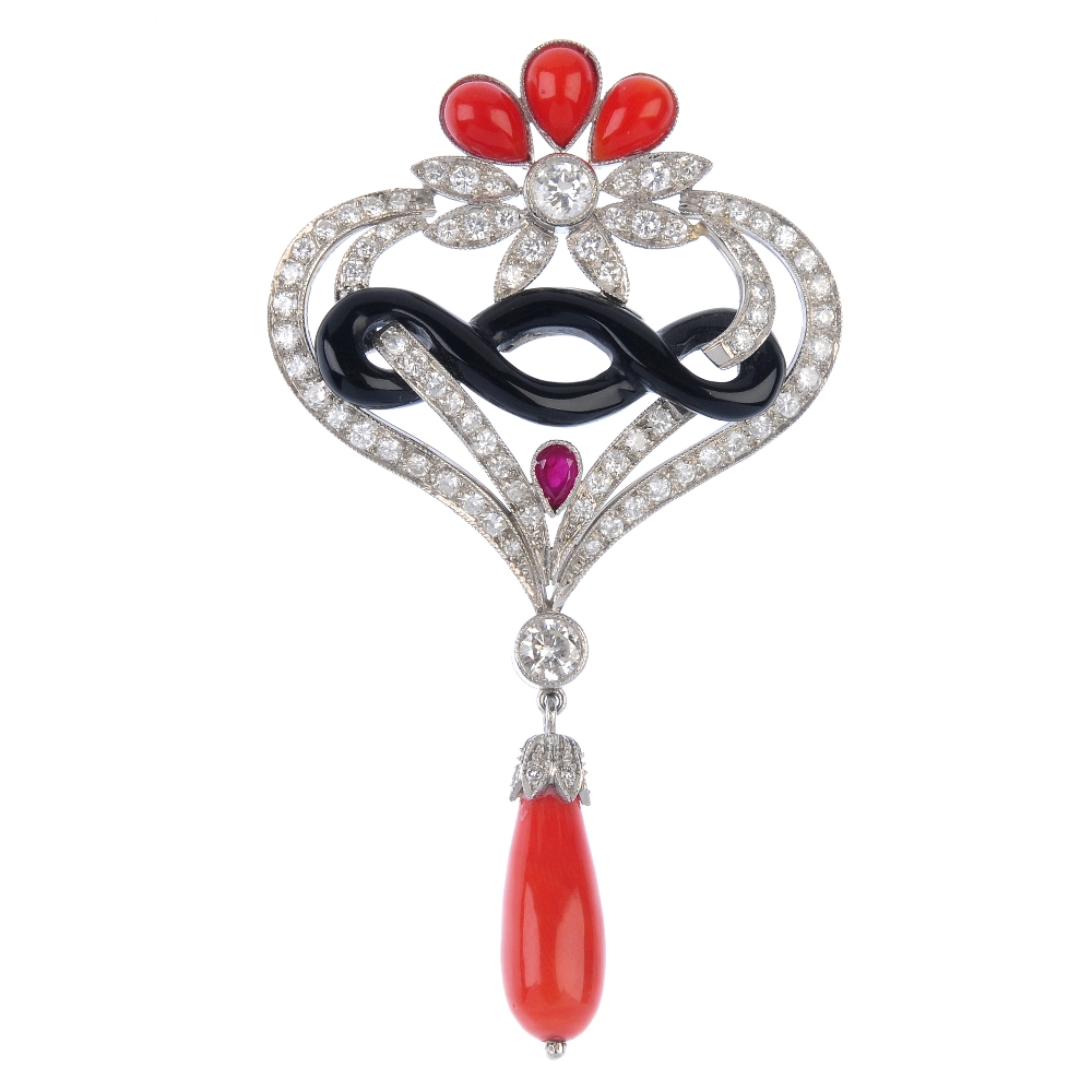 A diamond and gem-set pendant. The tapered coral drop and brilliant-cut diamond cap, suspended