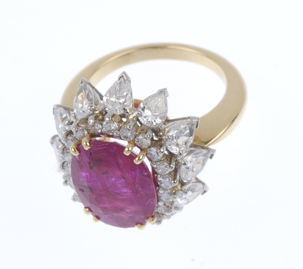 A ruby and diamond floral cluster ring. The oval-shape ruby, within a brilliant-cut diamond - Image 2 of 5