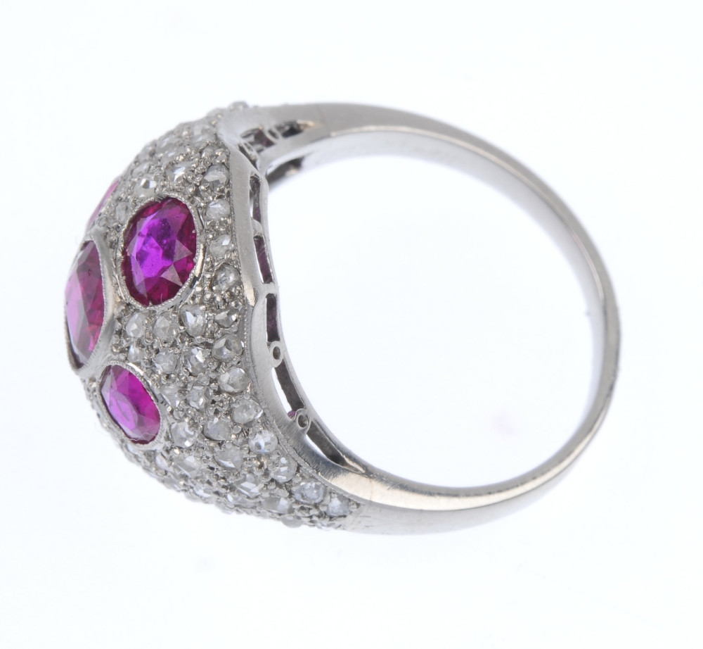 A ruby and diamond dress ring. The oval and rectangular-shape ruby cross, within a rose-cut - Image 3 of 4