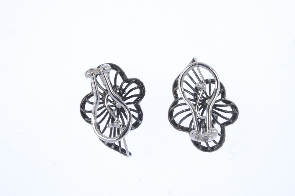 A pair of 18ct gold diamond floral earrings. Each designed as a graduated brilliant-cut diamond - Image 2 of 2