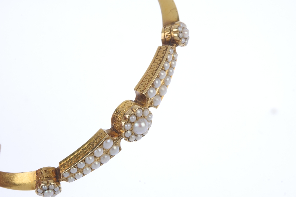 A late 19th century gold split pearl hinged bangle. The front designed as a series of three - Image 2 of 3