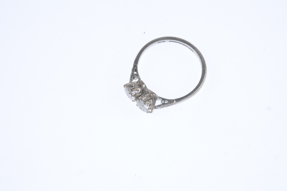 A diamond two-stone ring. The circular-cut diamond duo, with single-cut diamond line sides, to the - Image 2 of 3