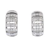 A pair of diamond earrings. Each designed as a series of brilliant-cut diamond curved lines.