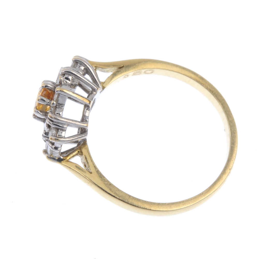 An 18ct gold sapphire and diamond cluster ring. The oval-shape orange sapphire, within an - Image 3 of 4