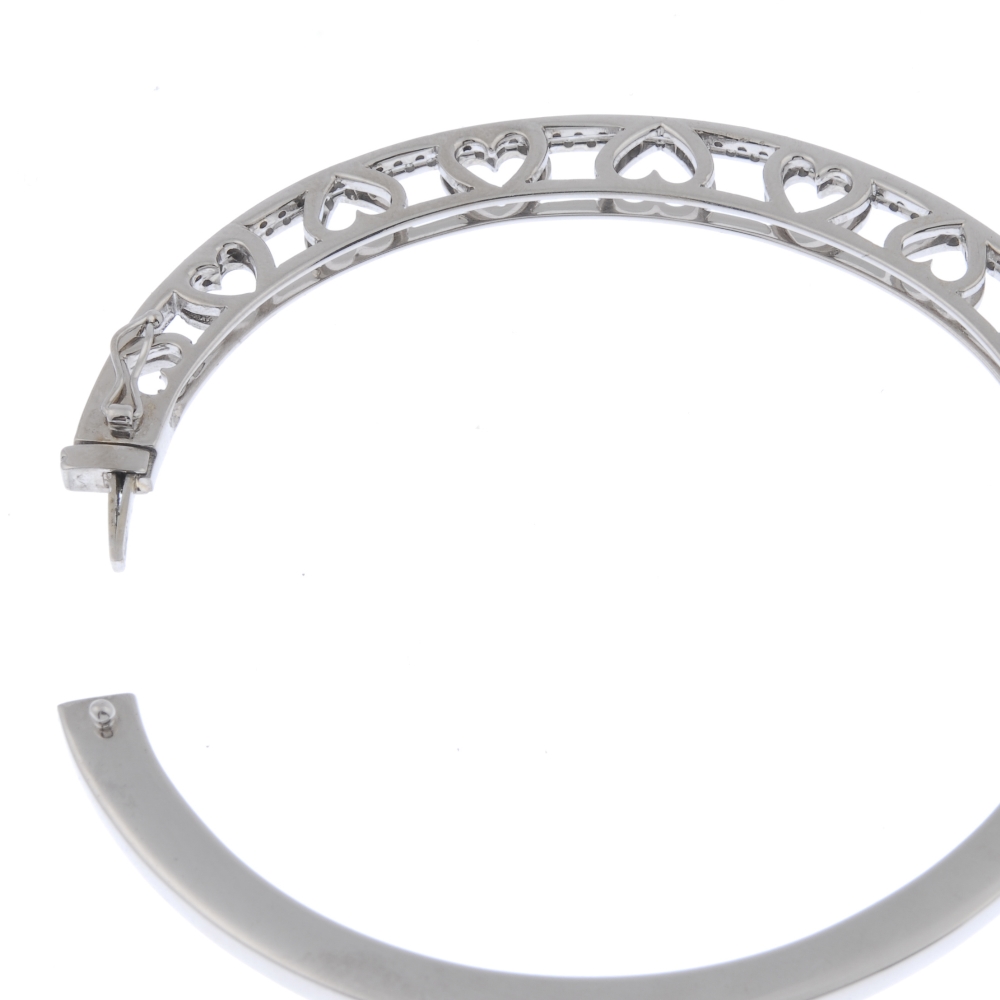 A diamond hinged bangle. The front designed as two brilliant-cut diamond lines, to the heart-shape - Image 3 of 3