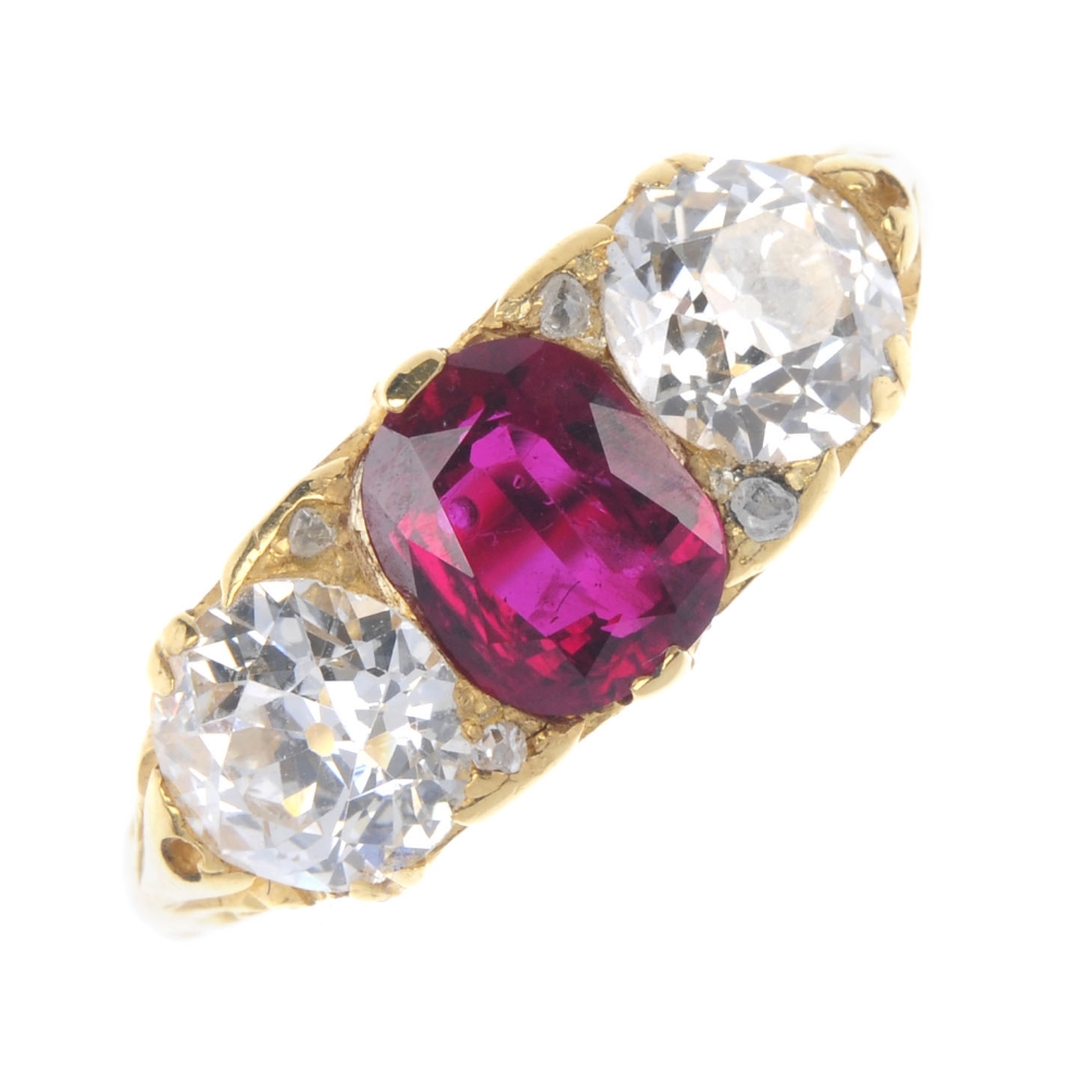 A ruby and diamond three-stone ring. The rectangular-shape ruby and old-cut diamond line, with