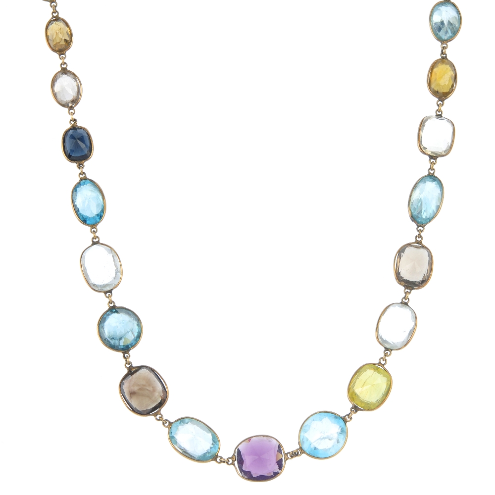 A multi gem-set necklace. The graduated vari-shape gem-set line, consisting of vari-hue zircon,