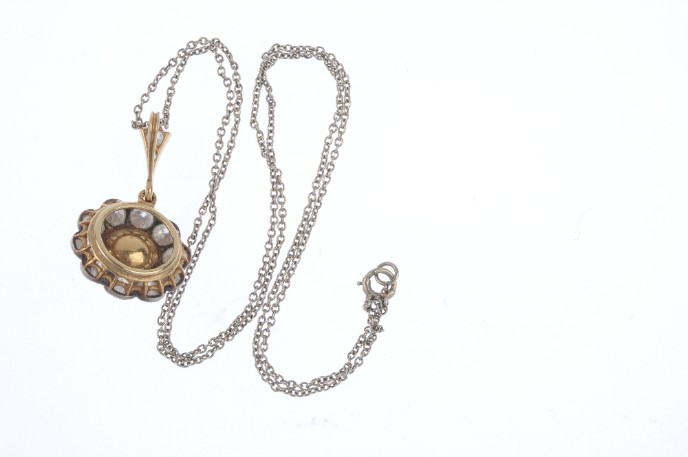 An early 20th century gold cat's-eye chrysoberyl and diamond cluster pendant. The oval cat's-eye - Image 2 of 3