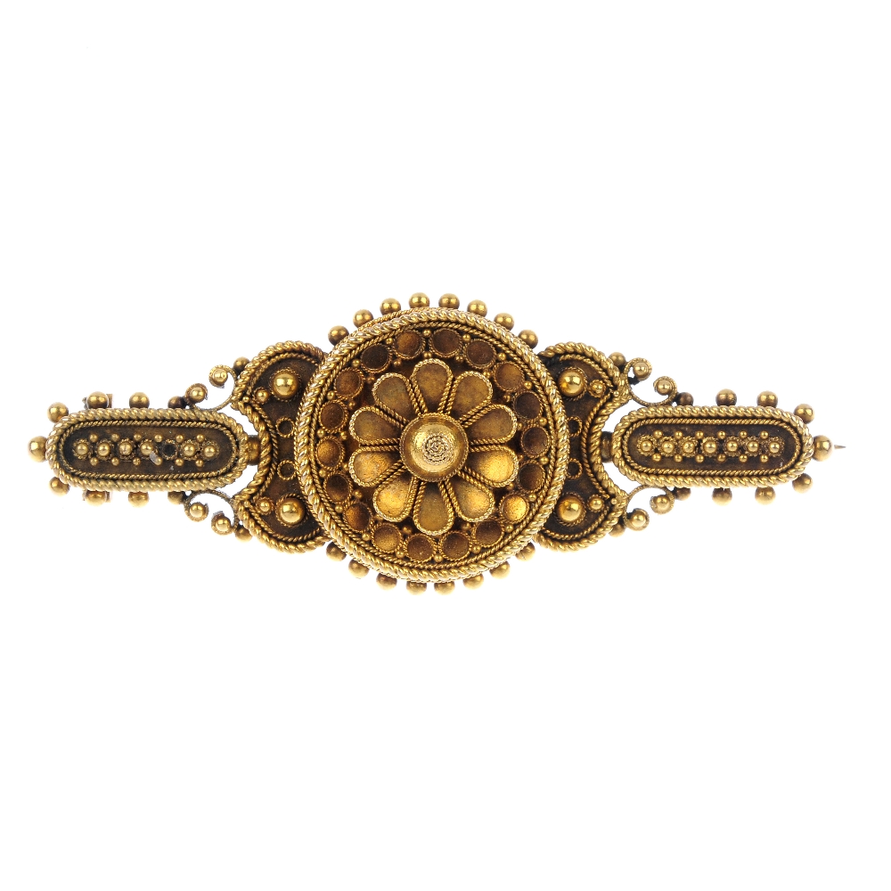 A late 19th century gold brooch. The floral centre, within a cannetille surround, to the similarly-