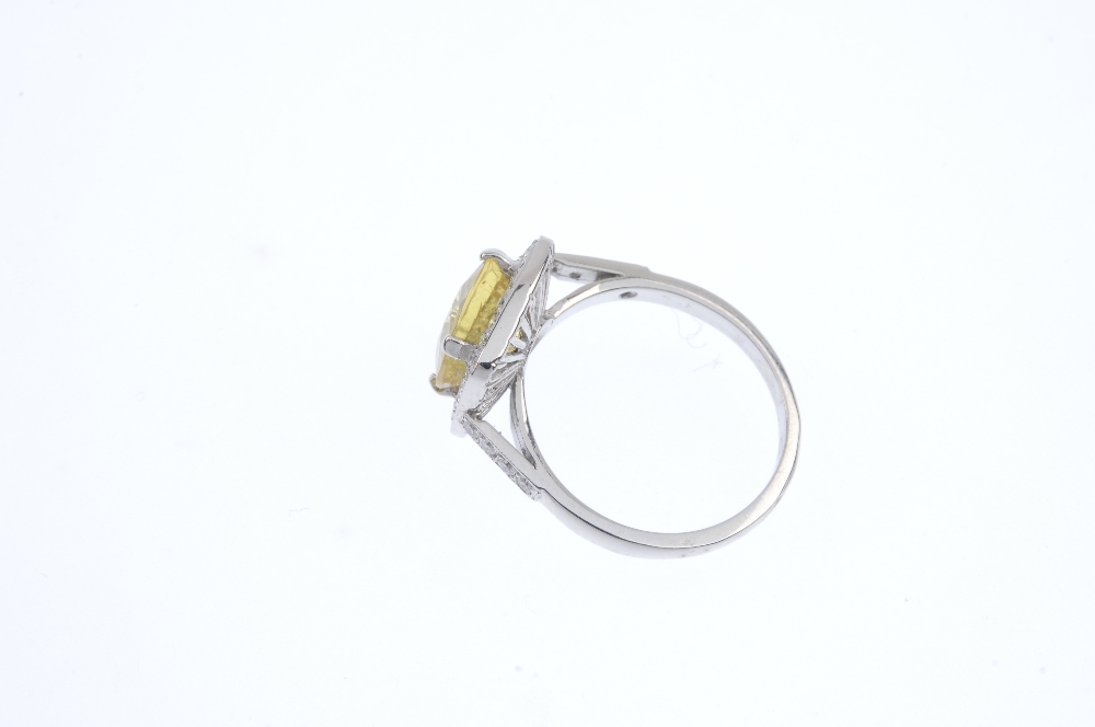 A sapphire and diamond dress ring. The cushion-shape yellow sapphire, with brilliant-cut diamond - Image 3 of 4