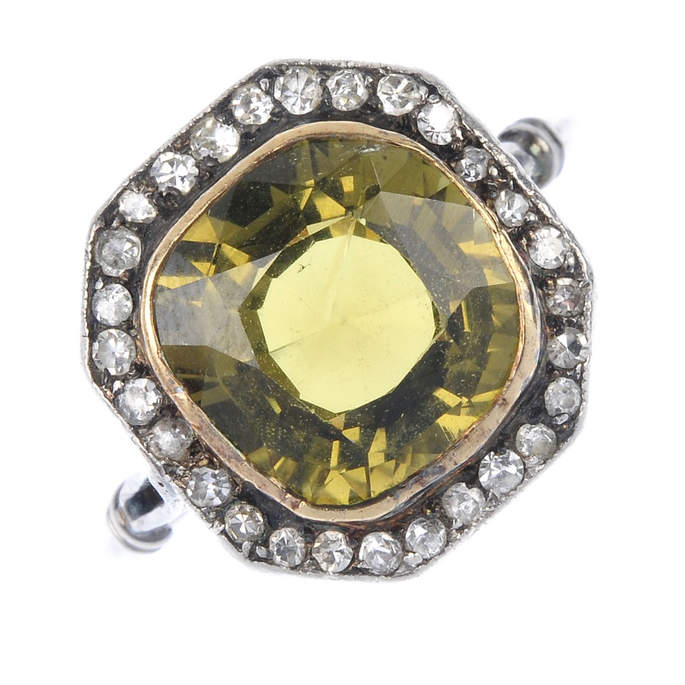 A mid 20th century chrysoberyl and diamond cluster ring. The cushion-shape yellowish green
