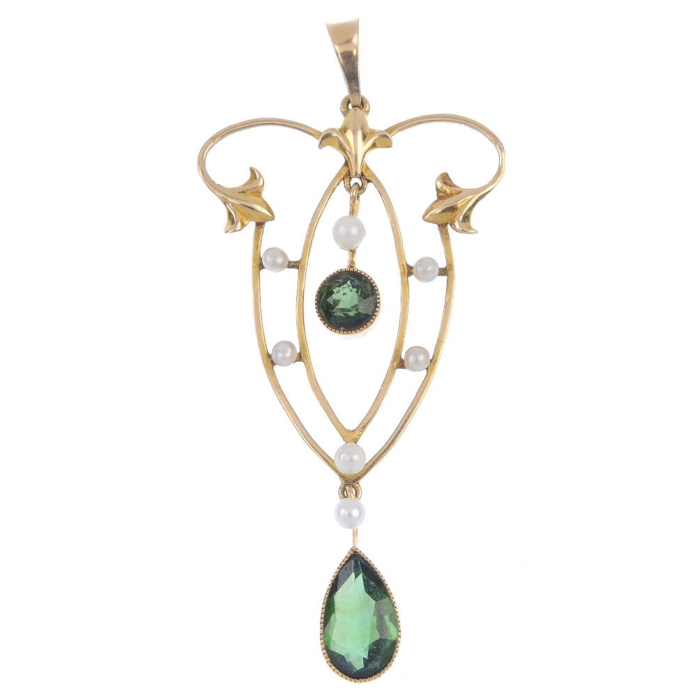 An early 20th century 9ct gold tourmaline and seed pearl pendant. Of openwork design, the pear-shape