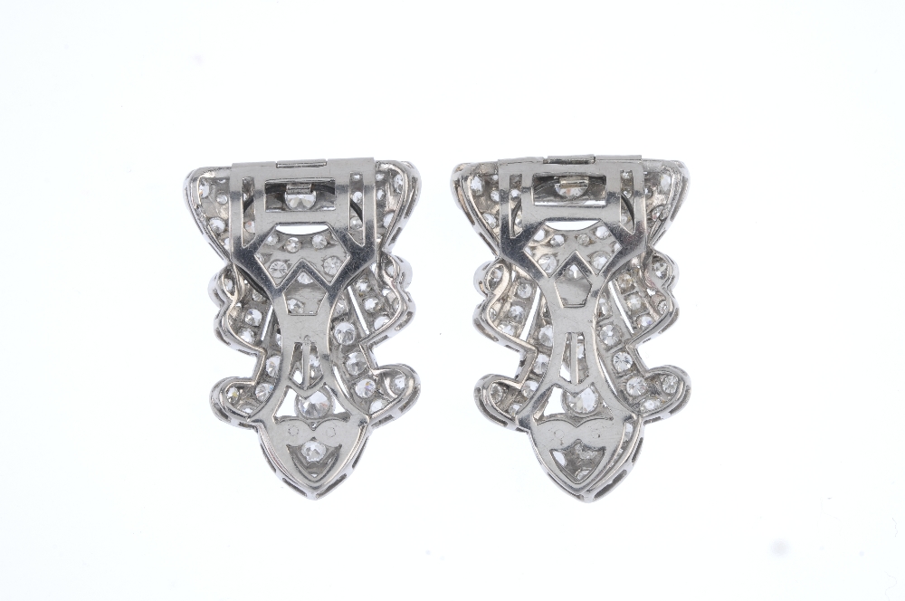 A pair of mid 20th century diamond clip brooches. Of openwork design, the geometric panels, set - Image 2 of 2