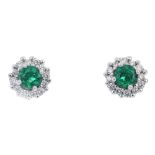 A pair of 18ct gold emerald and diamond cluster ear studs. Each designed as a circular-shape