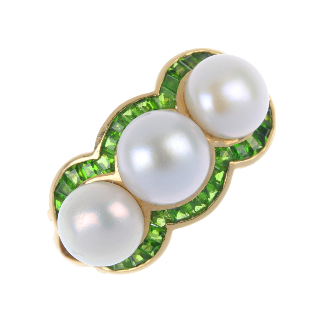 A cultured pearl and garnet cluster ring. The three cultured pearls, within a square-shape green