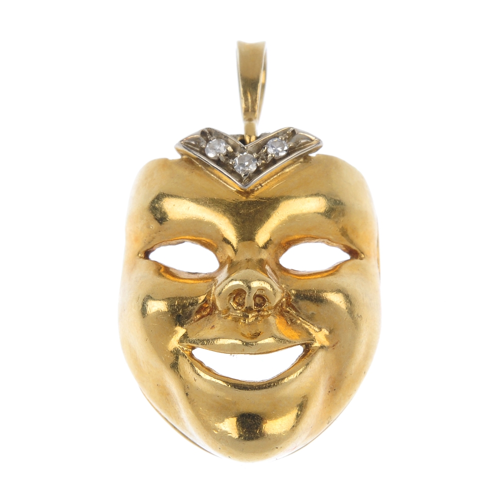 A diamond mask pendant. Designed as a smiling face, with single-cut diamond chevron highlight,