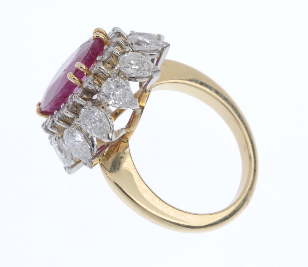 A ruby and diamond floral cluster ring. The oval-shape ruby, within a brilliant-cut diamond - Image 3 of 5