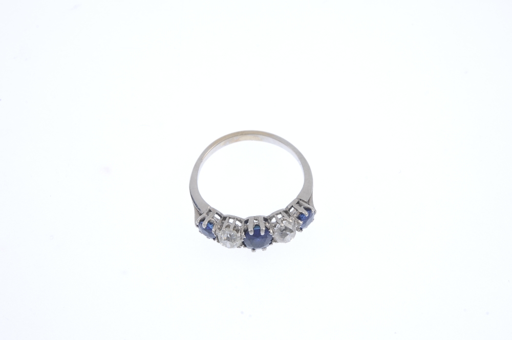 An early 20th century platinum and gold, sapphire and diamond ring. The alternating graduated oval- - Image 2 of 4