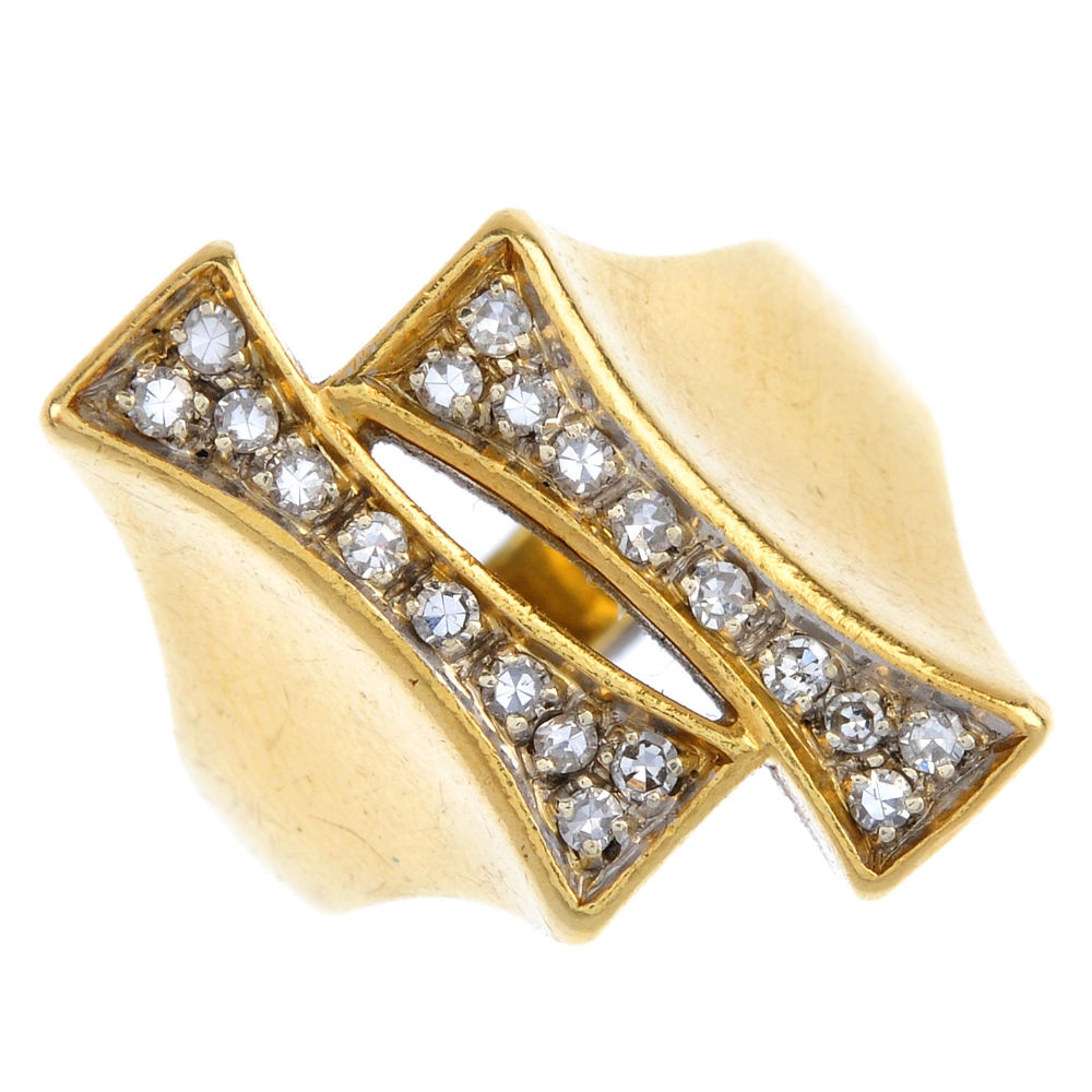 An 18ct gold diamond dress ring. Of asymmetric design, the staggered tapered panels, set with