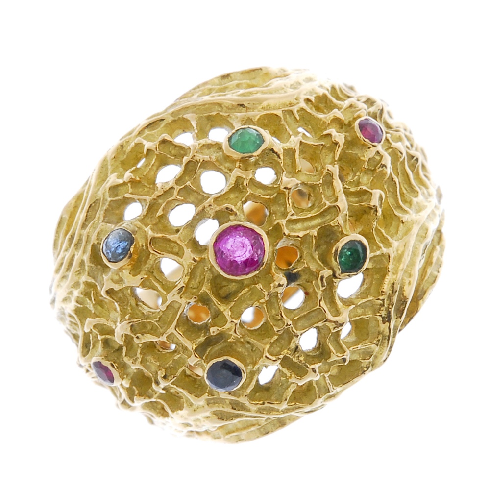 A sapphire, emerald and ruby ring. Designed as a textured openwork dome, with circular-shape