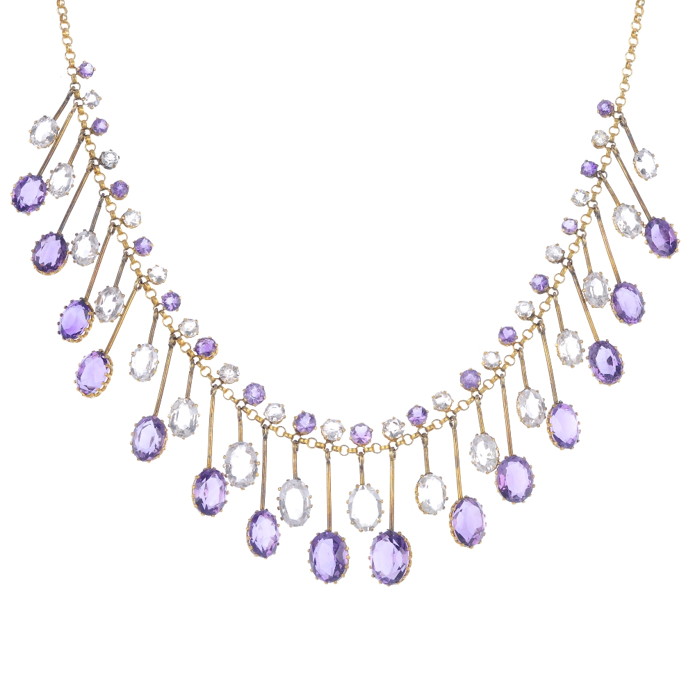 An amethyst and topaz fringe necklace. Designed as a series of graduated oval-shape amethyst and