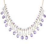 An amethyst and topaz fringe necklace. Designed as a series of graduated oval-shape amethyst and